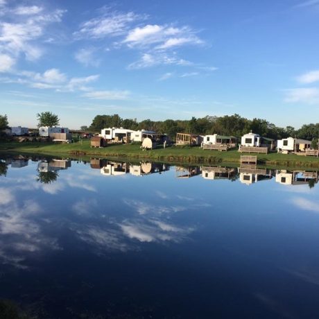 view of RV sites along the pond at Shady Lakes RV Resort