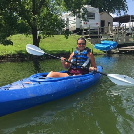 girl kayaking on pond at Shady Lakes RV Resort