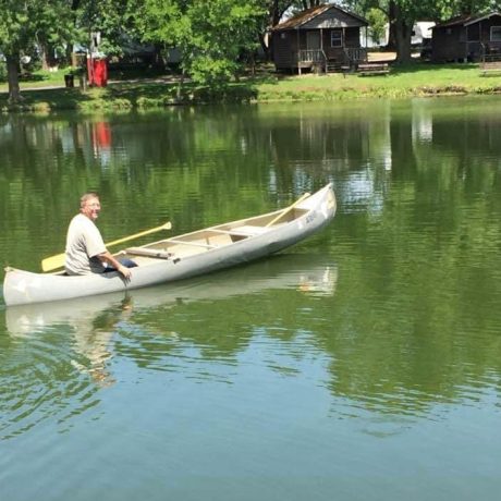 Man canoeing in the pond at Shady Lakes RV Resort
